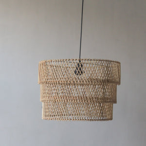 Handcrafted tiered rattan pendant light from Bali, showcasing unique design and natural elegance.