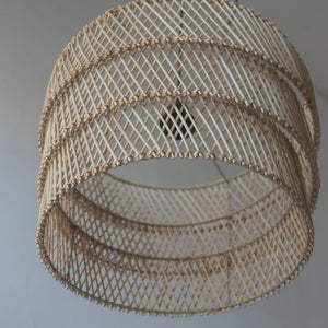 Handcrafted tiered rattan pendant light showcasing natural patterns and textures, perfect for unique home decor.