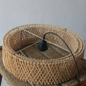 Handcrafted tiered rattan pendant light, showcasing unique artisan design from Bali, Indonesia.