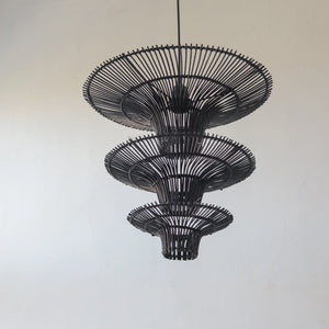 Handcrafted black rattan chandelier with three tiers, showcasing unique artisan motifs from Bali, Indonesia.