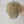 Handmade woven rattan pendant light with intricate spiral design against white wall.