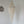 Handmade Balinese seashell chandelier with intricate beadwork hanging in a minimalist room