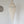 Handcrafted Balinese seashell chandelier with intricate beaded design hanging on white wall
