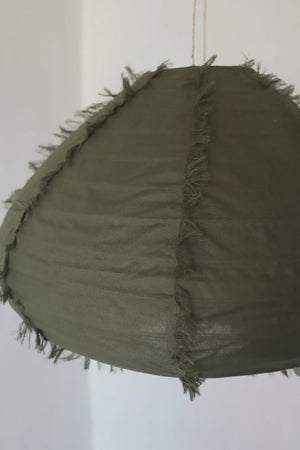 Handmade olive green fabric pendant lamp with fringe detail on a white background