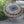 Large black and gold Balinese decorative umbrella with intricate floral patterns outdoors