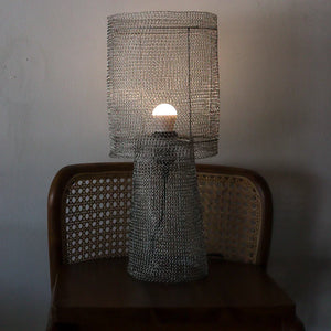 Handmade metal mesh table lamp with geometric shade on wooden chair, modern decor
