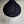 Handmade black woven pendant lamp shade against a neutral wall, eco-friendly home decor