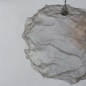 Handmade wire mesh pendant light with organic sculpted form against a plain background