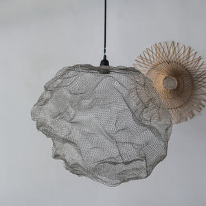 Modern wire mesh pendant lamp with sculptural design hanging in minimalist room