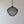 Handmade black mesh pendant light with sculptural design against a neutral wall