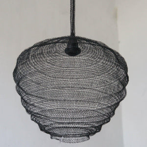 Handmade black wire pendant light with layered, organic shape against white wall