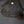 Handcrafted wire mesh pendant light with organic, sculptural design hanging from ceiling