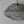 Handmade wire mesh pendant lamp with organic cloud-like shape against a neutral wall