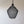 Handmade black mesh pendant light with organic shape against neutral wall