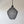 Handmade black mesh pendant light with organic, sculptural design hanging against a plain wall