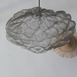 Handmade wire mesh ceiling lamp with organic shape on light background