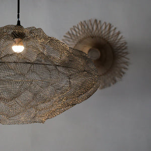 Handcrafted Balinese wire mesh pendant light with woven rattan wall decor