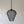 Handmade black wire pendant lamp with scalloped edges hanging against a neutral wall