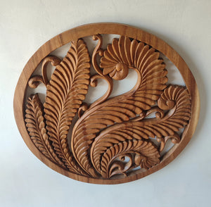 Hand-carved Balinese wooden wall art featuring intricate leaf and floral patterns