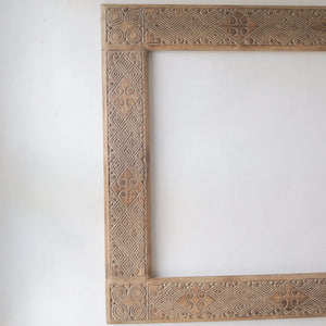 Hand carved wooden mirror frame from Bali, Indonesia, featuring unique ethnic motifs and intricate designs.