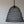 Handwoven black wire pendant light with a wavy dome shape against a neutral wall