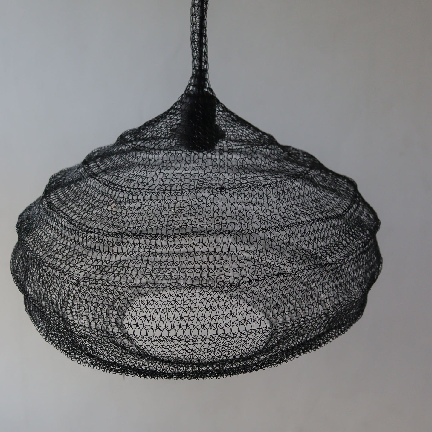 Black wire mesh chandelier with unique handcrafted design, perfect for modern interiors.