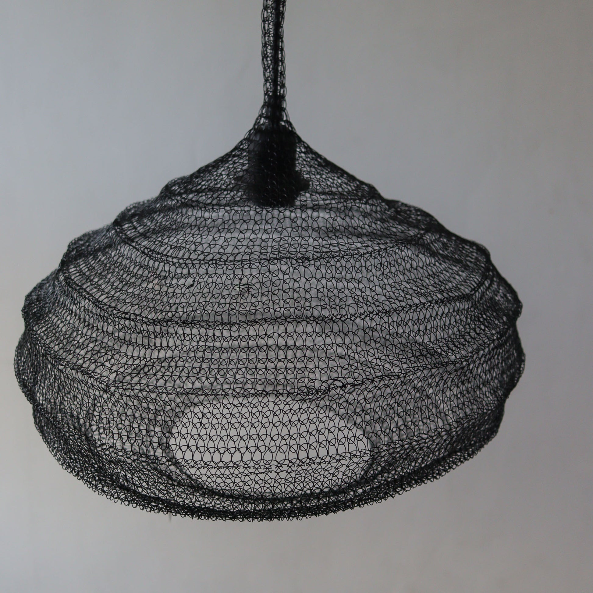 Black wire mesh chandelier with unique handcrafted design, perfect for modern interiors.