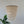 Handmade seashell chandelier with cascading white shells, natural decor above green plant