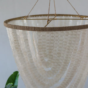Handmade seashell chandelier with cascading white shell strands and natural fiber accents