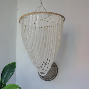 Handmade Balinese seashell chandelier with white hanging shells in a modern interior