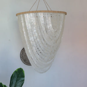 Handmade Balinese seashell chandelier with layered white shell strands, boho home decor