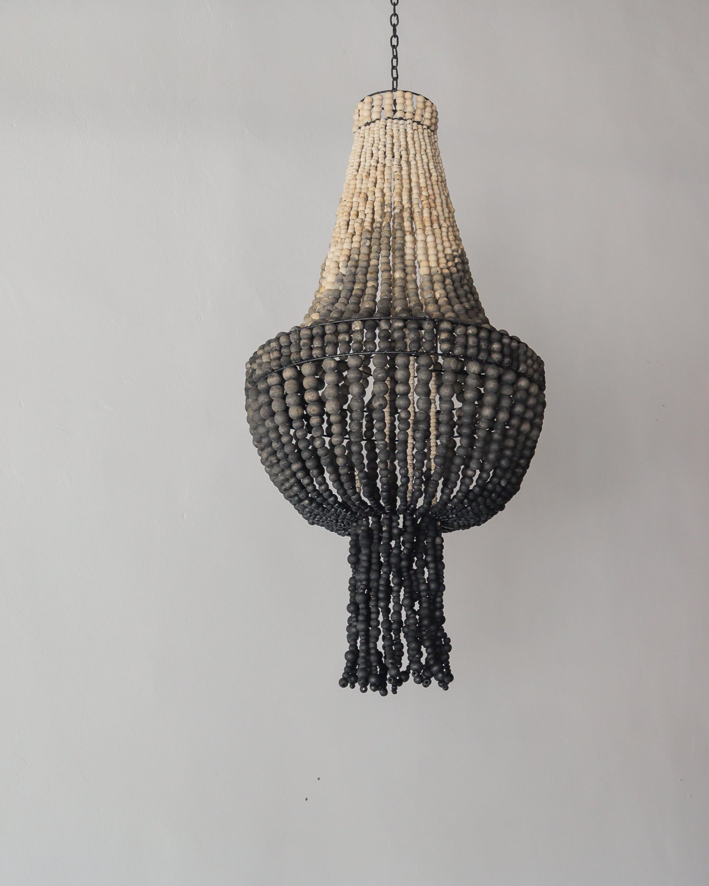 Beaded chandelier in ombre color, handcrafted in Bali, adds unique elegance to any space.