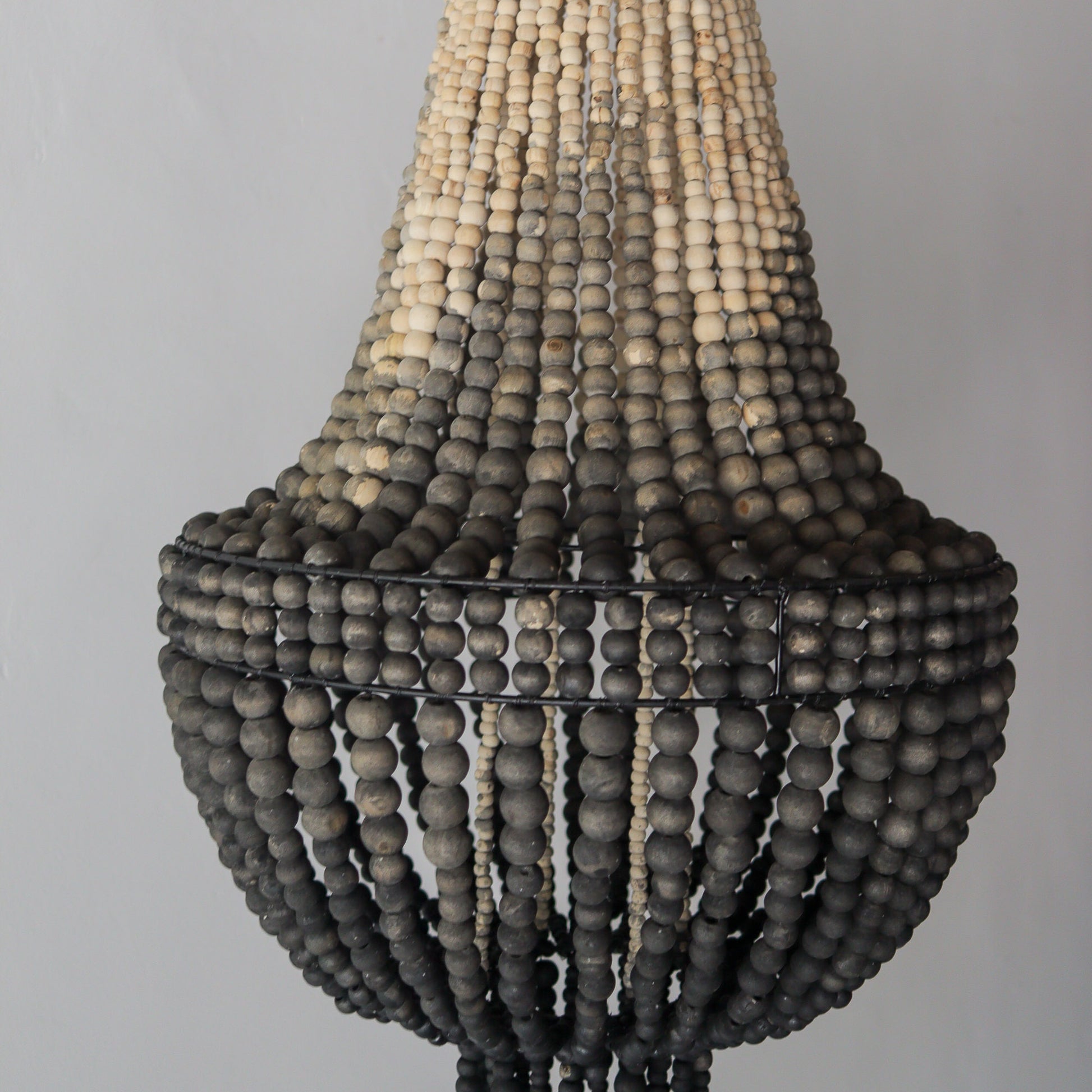 Beaded chandelier in ombre color, handcrafted in Bali, showcasing unique earthy tones and intricate design.
