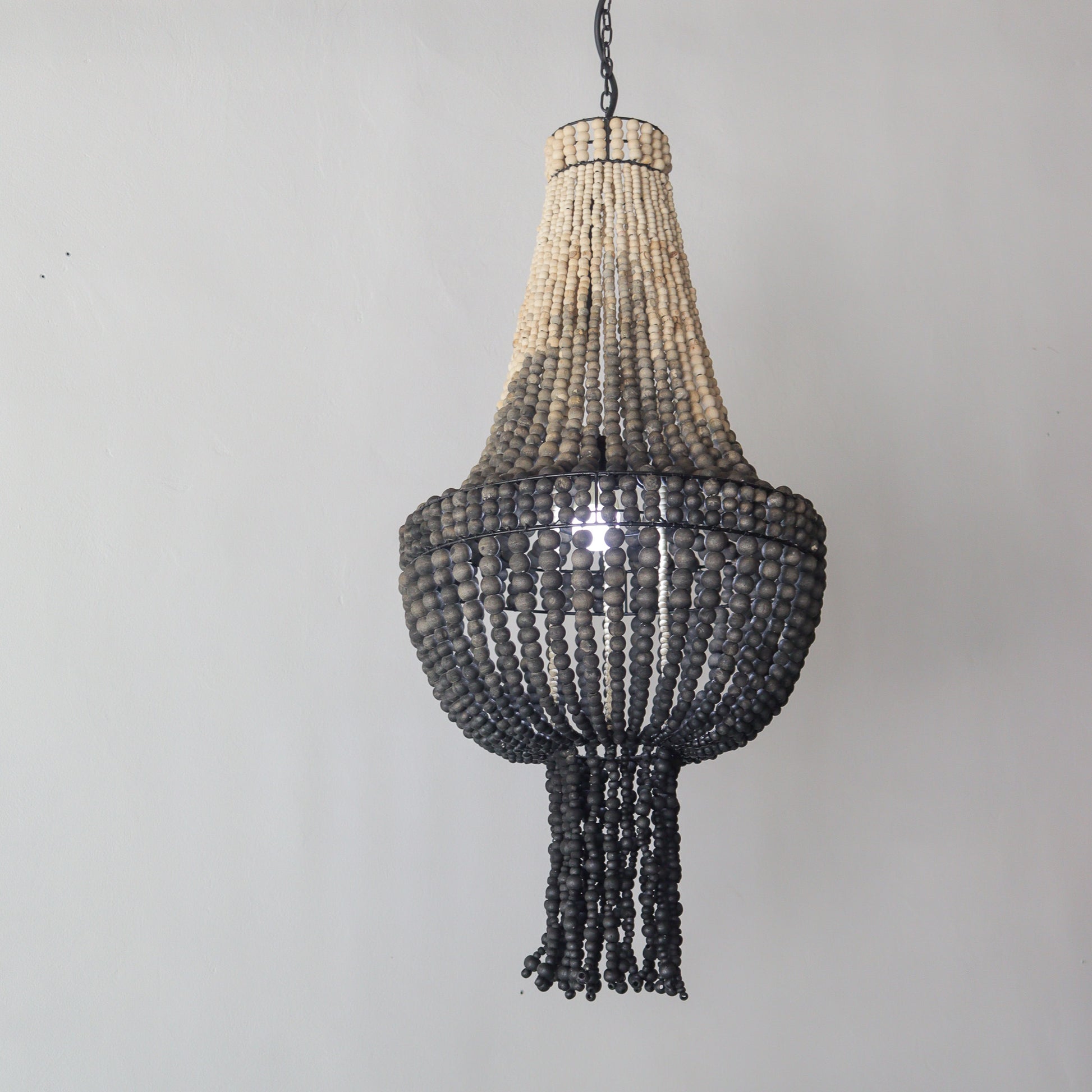 Beaded chandelier with ombre color design, handcrafted in Bali, perfect for stylish home decor.