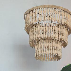 Handmade Balinese wooden bead chandelier with layered natural finish, hanging indoors