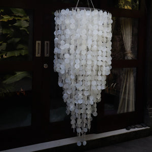 Handmade Balinese seashell chandelier with cascading white capiz shells outdoors