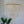 Handmade seashell chandelier with cascading strands, boho coastal decor, plant nearby