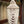 Handmade Balinese seashell chandelier with intricate beading, hanging by a window