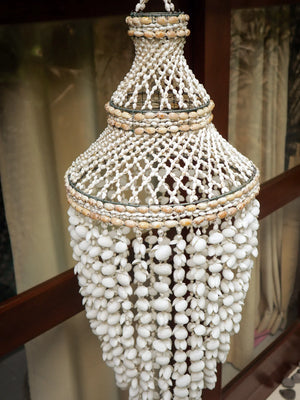 Handmade Balinese seashell chandelier with intricate dangling shells, boho home décor