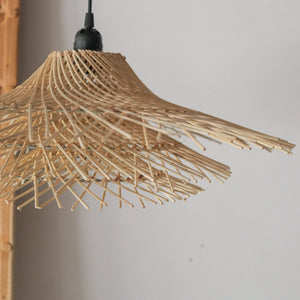 Handcrafted tiered rattan pendant light showcasing intricate design and natural textures from Bali, Indonesia.