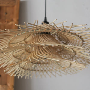 Handcrafted rattan pendant light in tiered Jerami design, showcasing natural motifs from Bali, Indonesia.