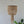 Handmade Balinese beaded chandelier with natural wood beads, hanging in a minimalist room