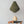 Olive green pendant lamp and wooden decor egg on rustic chair against neutral wall