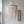 Handmade Balinese seashell chandelier with intricate draped design, hanging in a modern room