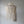 Handmade Balinese seashell chandelier with layered draped beads against a plain wall