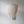 Handmade Balinese seashell chandelier with layered white shells against a plain wall