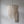 Handmade Balinese seashell chandelier with cascading beads against a neutral wall