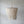Handmade Balinese seashell chandelier with cascading strands against a plain wall