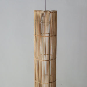 Handcrafted rattan pendant light featuring a tube design, showcasing natural variations and unique craftsmanship from Bali.