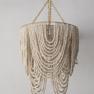 Beaded chandelier in white and gold, handcrafted decor from Bali, Indonesia, perfect for any elegant room.